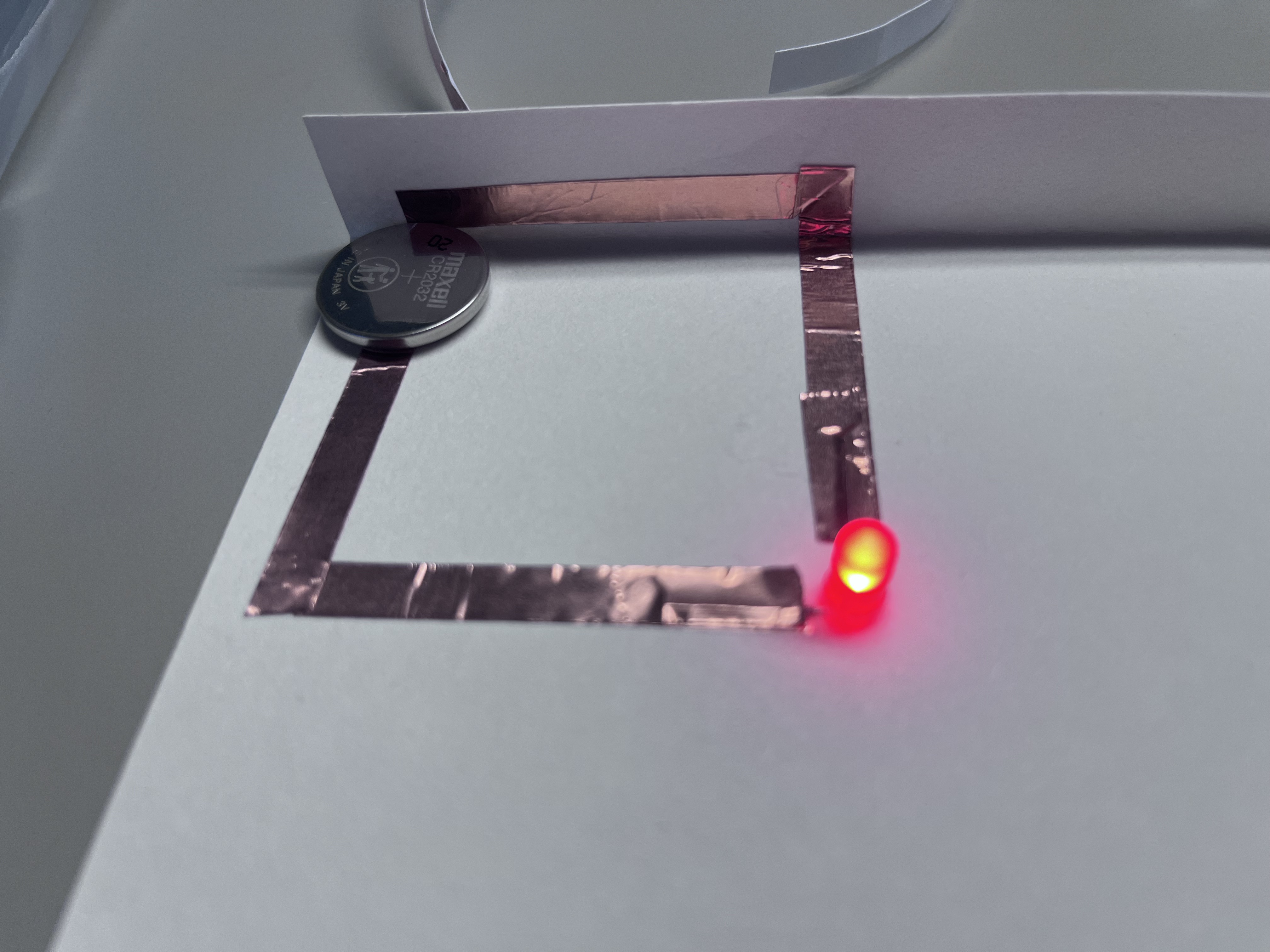 Successfully completing a series circuit and observing stable light activation.