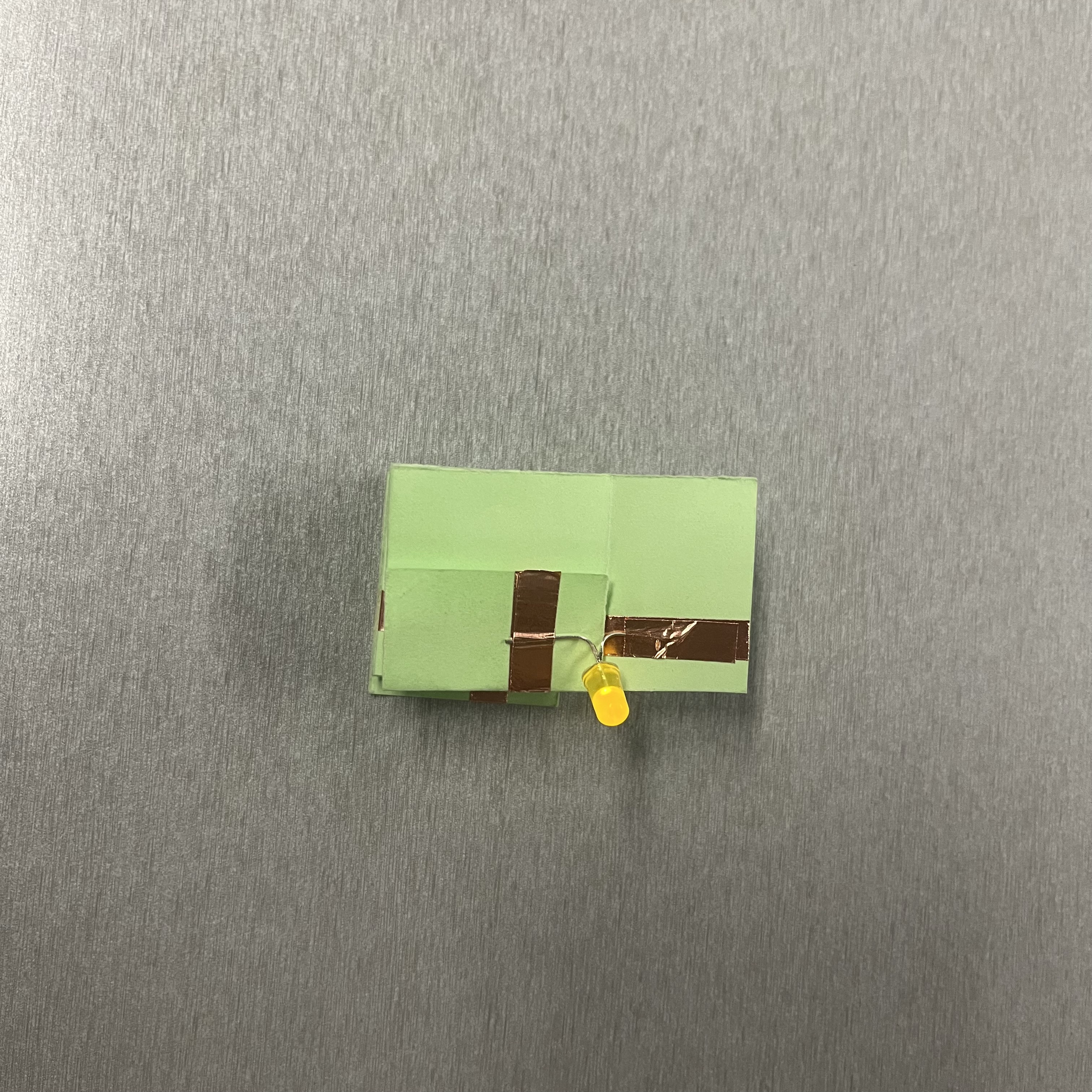 Observing light activation when the paper spring structure relaxes and restores proper flow.