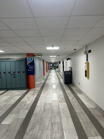The first location, the E Wing hallway, represents a typical academic interior space. Its long linear layout and bright reflective surfaces create a strong sense of order and direction, evoking the disciplined rhythm of campus life. The clean design, accented by orange pillars and blue signage, reinforces both functionality and visual identity, guiding movement and emphasizing the institutional character of Sheridan’s learning environment.<a href='https://www.youtube.com/embed/tgbNymZ7vqY' target='_blank'><p>Project Video Link</p></a>